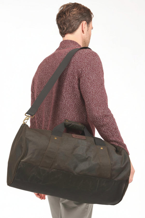 Dark olive waxed canvas duffle bag with leather-look handles and side button tabs