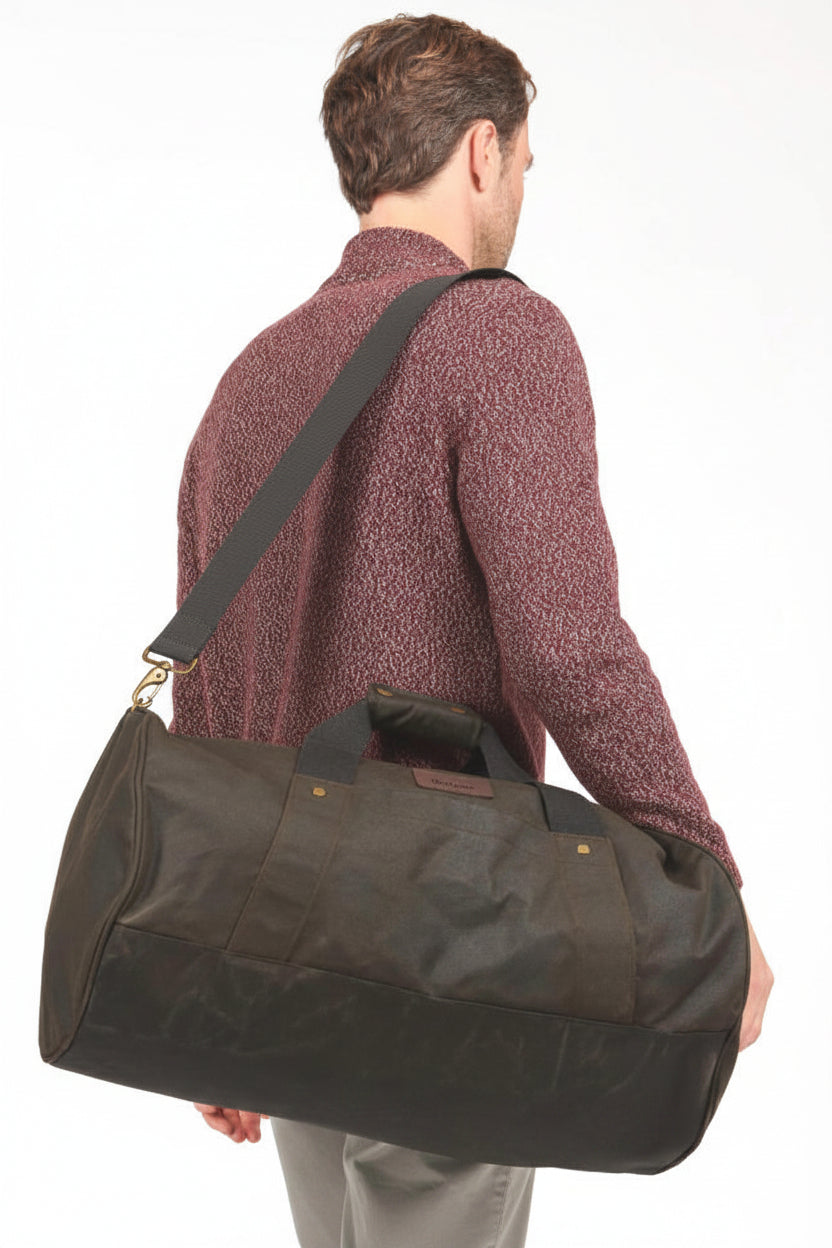 Dark olive waxed canvas duffle bag with leather-look handles and side button tabs