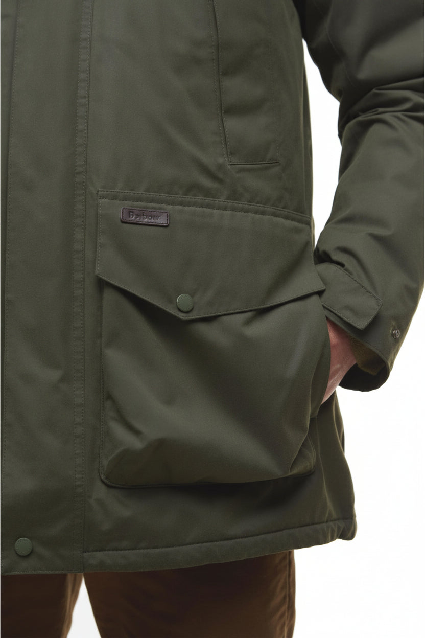 Olive green waterproof jacket detail: flap pocket with Barbour logo patch