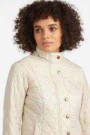 Women’s light-cream quilted jacket with high collar, snap-button placket, diamond quilting