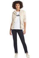 Women’s light-cream quilted jacket with stand collar and snap front, worn with dark jeans
