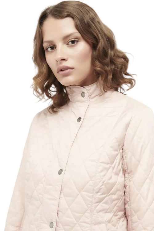 Light pink quilted jacket close-up with button placket and stand collar