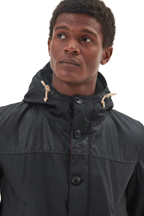 Men's black Barbour wax parka with hood drawstrings and button placket