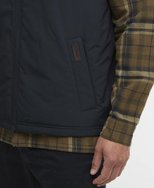 Navy gilet vest with chest pocket tab detail and visible part of front zip