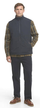 Navy sleeveless gilet vest with full zip, worn over plaid shirt and dark trousers
