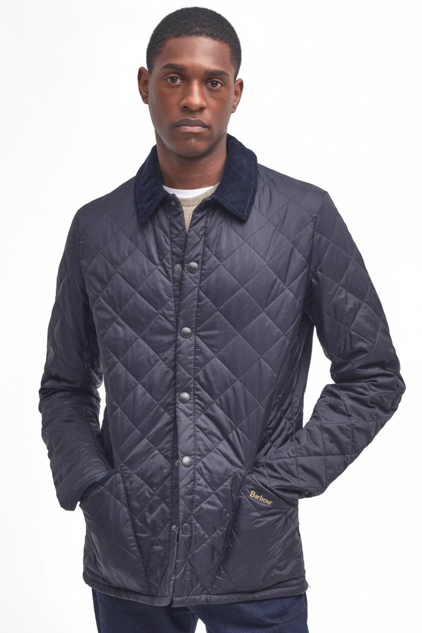 Men's navy quilted jacket with button front and Barbour logo patch on sleeve