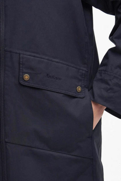 Navy parka jacket sleeve panel with logo patch and buttoned pocket flap