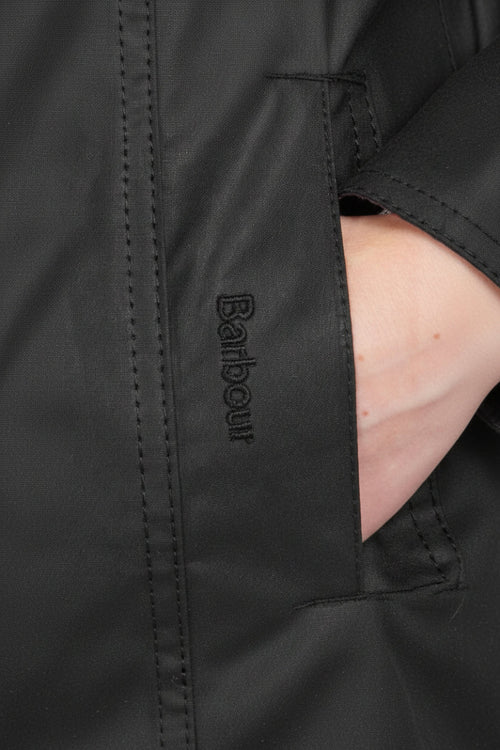 Barbour logo patch on inner cuff of black waxed waterproof coat