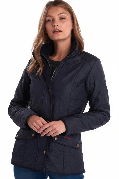 Navy quilted ladies jacket with zip front, stand collar, and gold-button cuffs