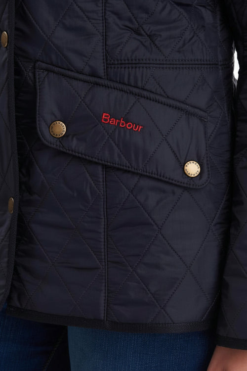 Navy quilted jacket with Barbour logo patch on chest and gold button details