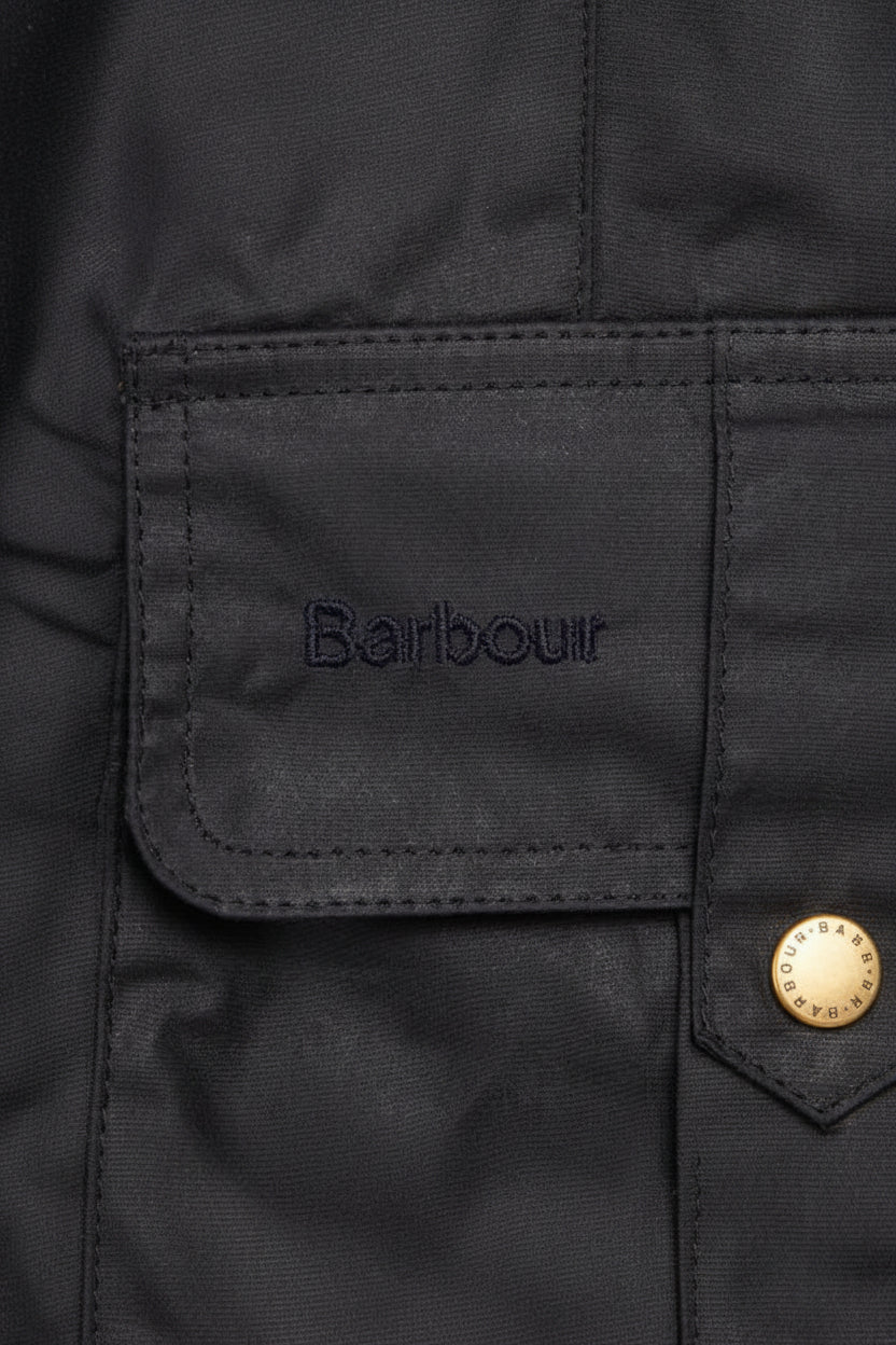 Barbour dark lightweight jacket fabric label patch on pocket flap with snap buttons