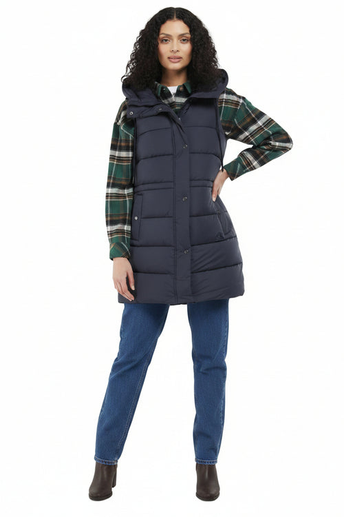 Navy quilted hooded gilet with button front, worn over plaid shirt and jeans