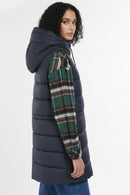 Navy quilted hooded gilet with button front, styled with plaid sleeves
