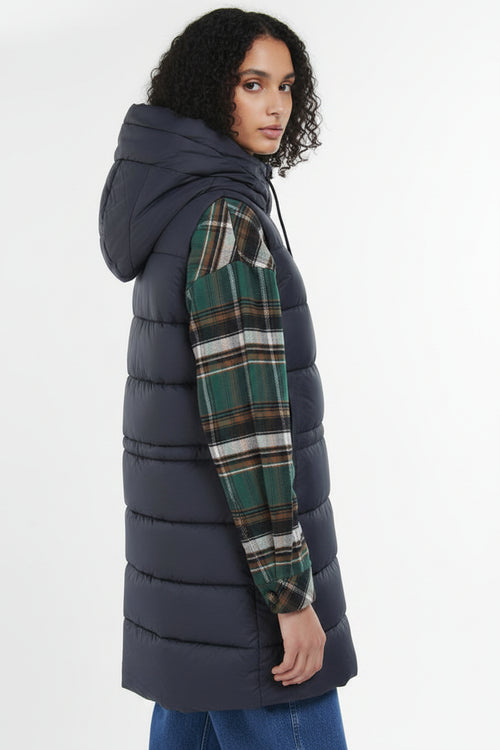 Navy quilted hooded gilet with button front, styled with plaid sleeves