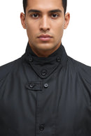 Men's black wax jacket neck close-up with layered collar and metal button fasteners
