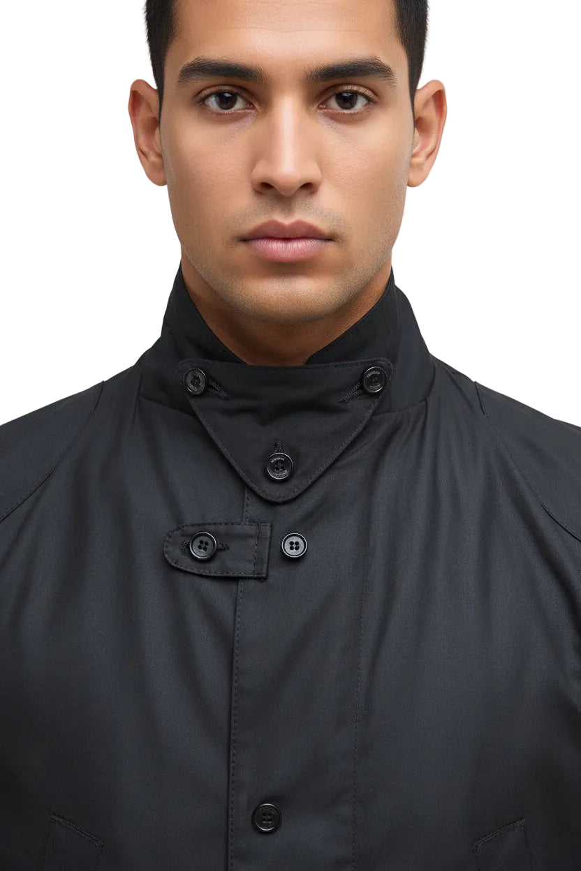 Men's black wax jacket neck close-up with layered collar and metal button fasteners