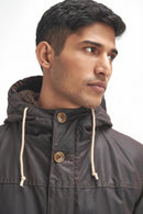 Men's dark wax parka with cord hood drawstrings and two round snap buttons.
