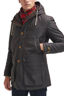 Men's dark hooded wax parka with cord drawstrings and front utility flap pockets.