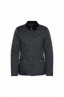 Men's black quilted jacket, front view, stand collar with snap buttons and Barbour logo