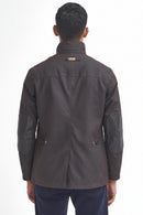Men's Barbour wax jacket in dark brown, back view with stand collar tag and flap pockets.