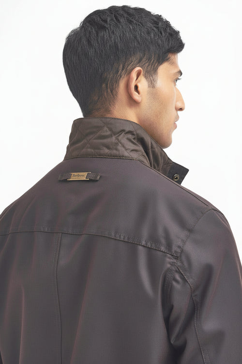 Men's Barbour wax jacket in dark brown, side view with stand collar and snap details.