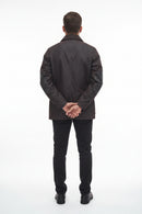 Men's Barbour wax jacket in dark brown, back view with center seam and snap cuffs.