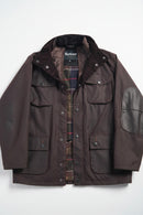 Men's Barbour wax jacket in dark brown with snap front, flap pockets, stand collar.
