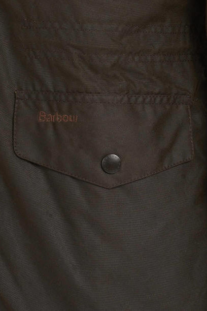 Men's olive wax jacket chest pocket with Barbour label and dark button