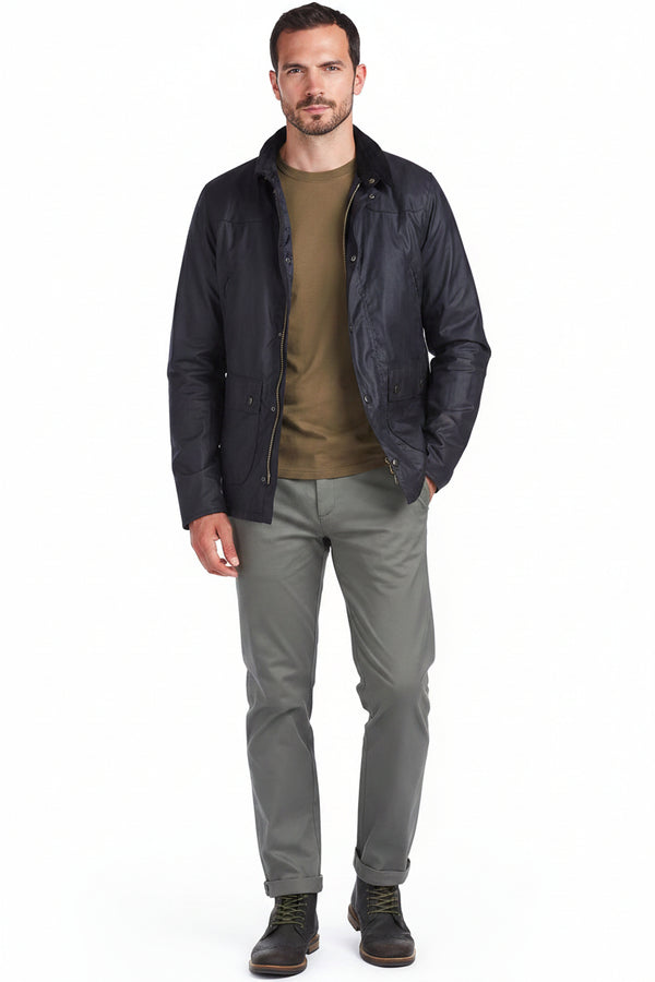 Men's navy waxcotton jacket with button front, worn over an olive crewneck.