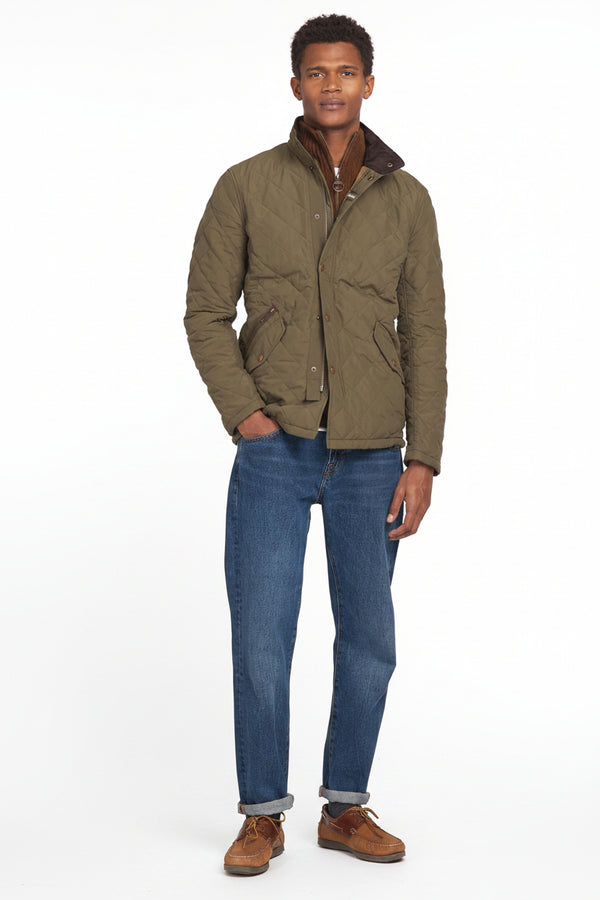 Men's army green quilted jacket worn with ribbed knit and button-up front