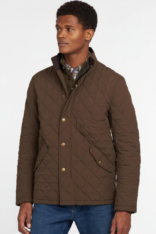 Men's olive quilted jacket with button front, stand collar, and side pockets.