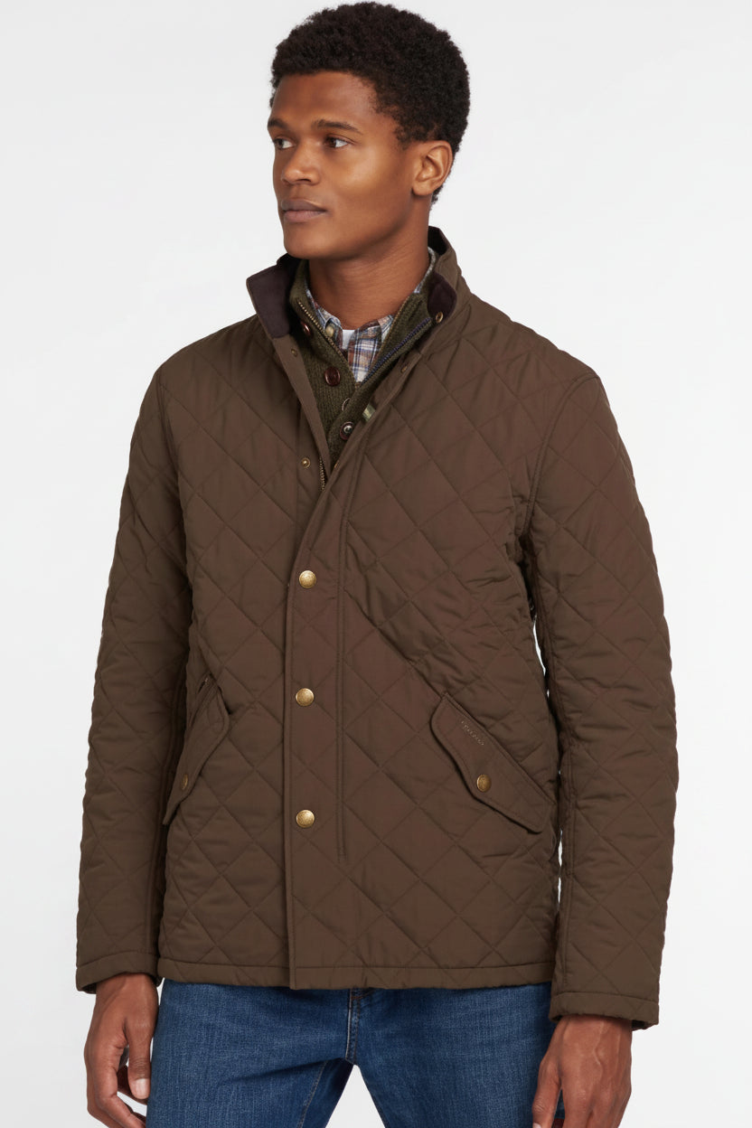 Men's olive quilted jacket with button front, stand collar, and side pockets.