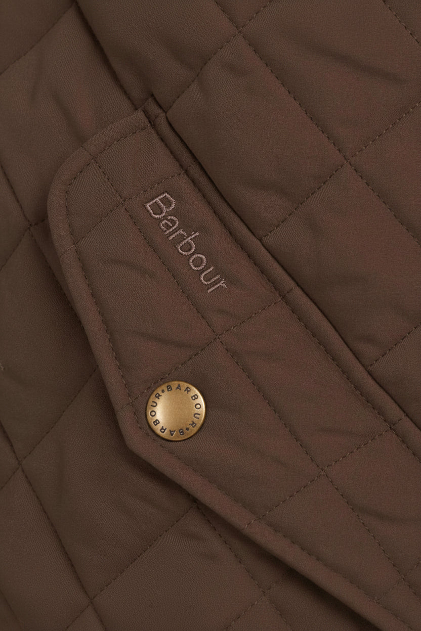 Barbour logo label on olive quilted jacket pocket flap with round gold button.