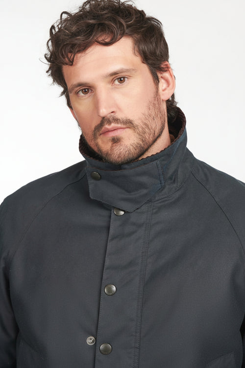 Men’s navy wax cotton jacket with snap front and dark brown corduroy collar
