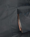 Navy wax cotton jacket inner seam and lining, with brown leather trim tag