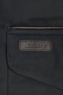 Barbour wax cotton jacket label on navy pocket flap, stitched edge detail