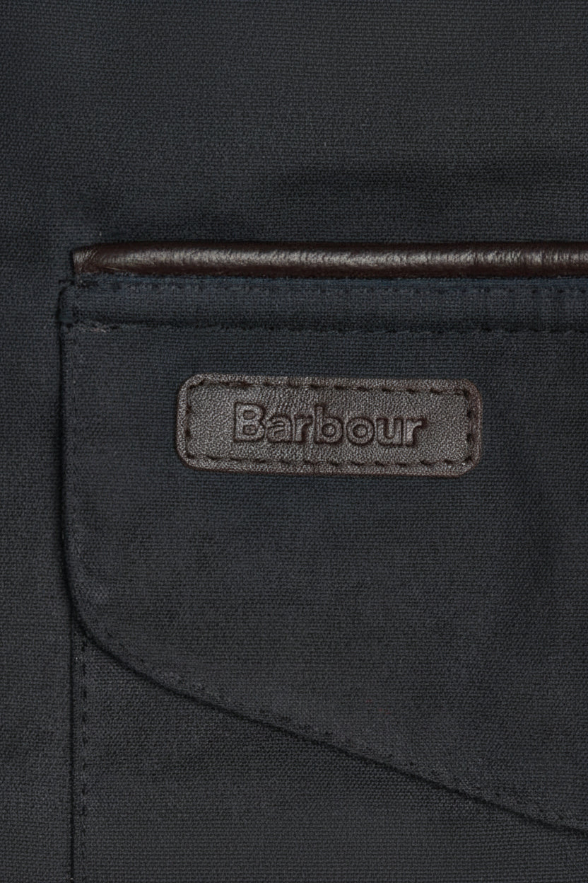 Barbour wax cotton jacket label on navy pocket flap, stitched edge detail