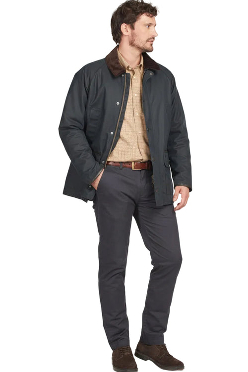 Men’s navy wax cotton jacket worn open, showing beige shirt and buttoned pockets