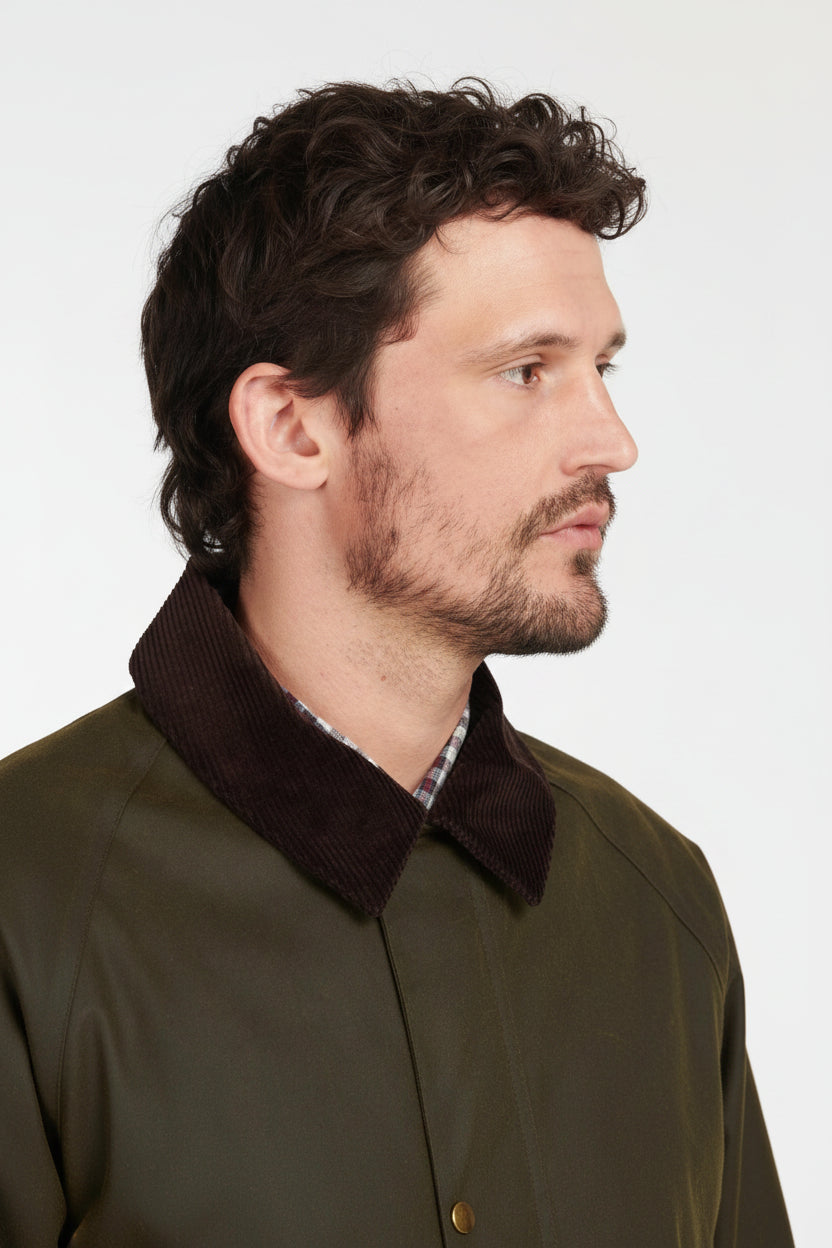 Olive wax cotton jacket worn by model, side view with dark collar