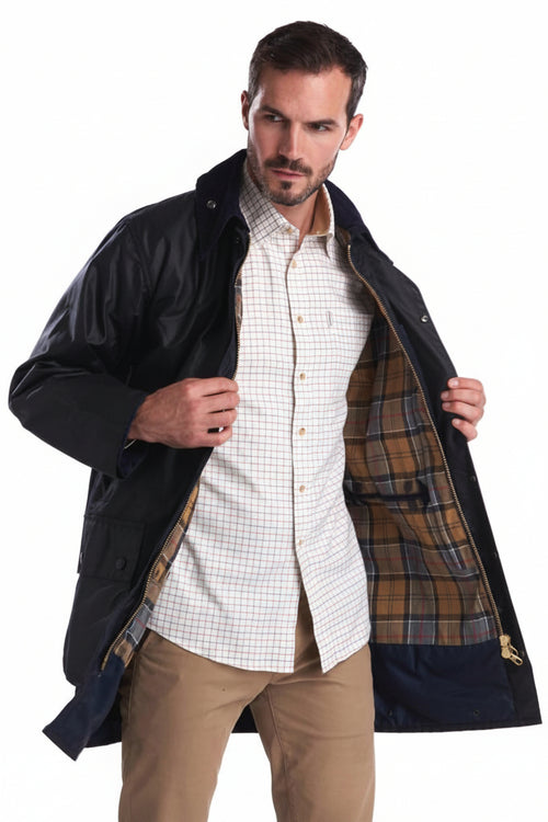 Men's navy wax jacket open front showing brown plaid lining and button details