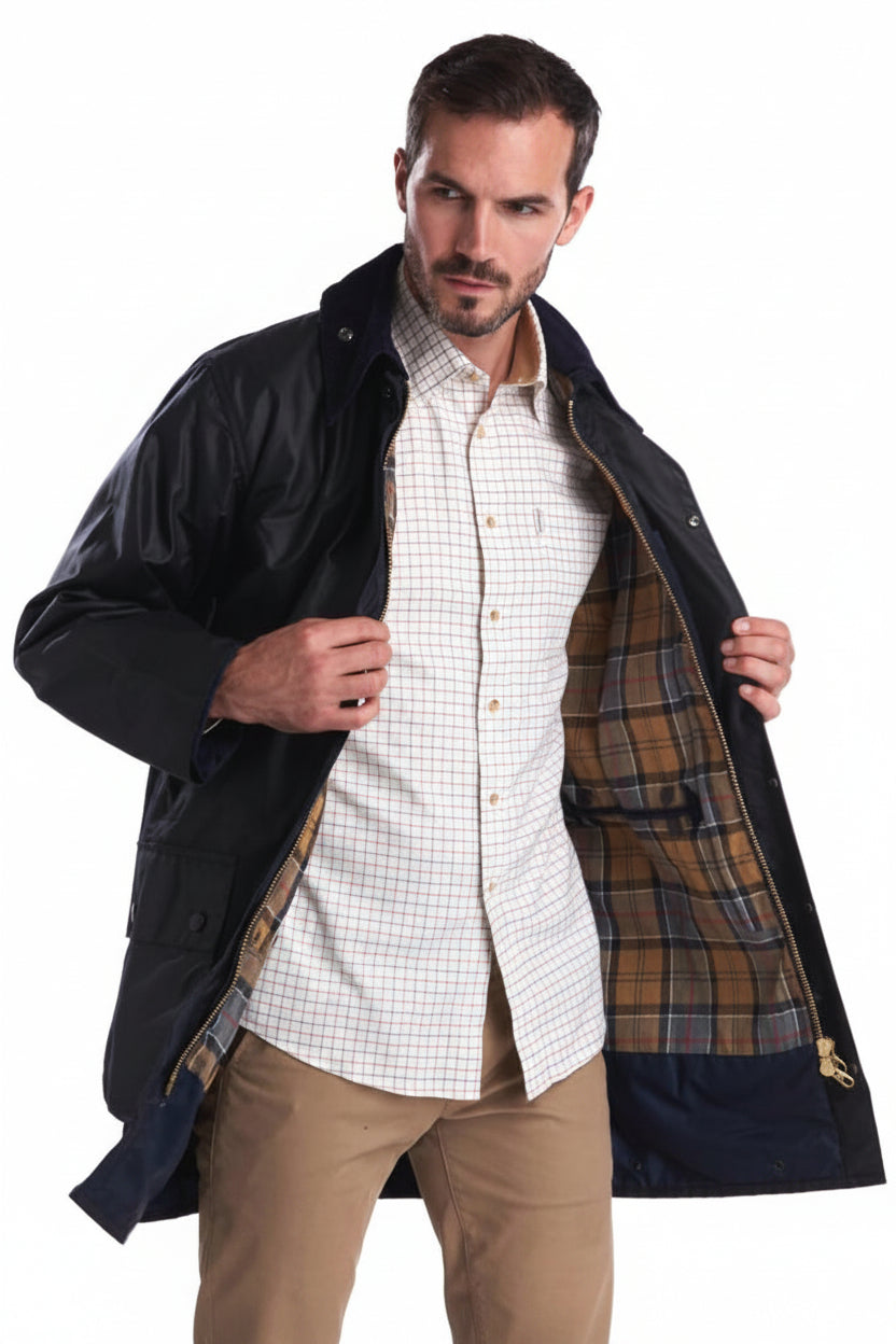 Men's navy wax jacket open front showing brown plaid lining and button details