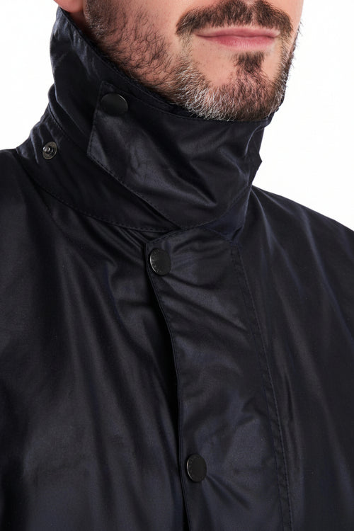 Men's navy wax jacket with high stand collar and snap-button throat placket