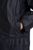 Men's navy wax jacket front with flap pockets and buttoned placket