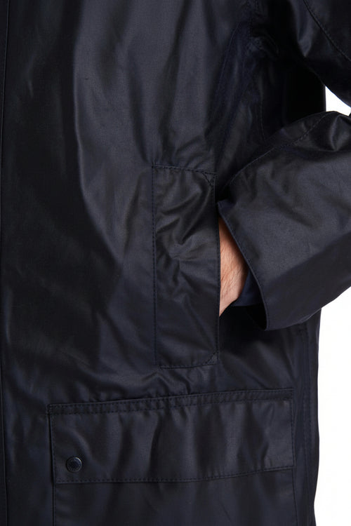 Men's navy wax jacket front with flap pockets and buttoned placket