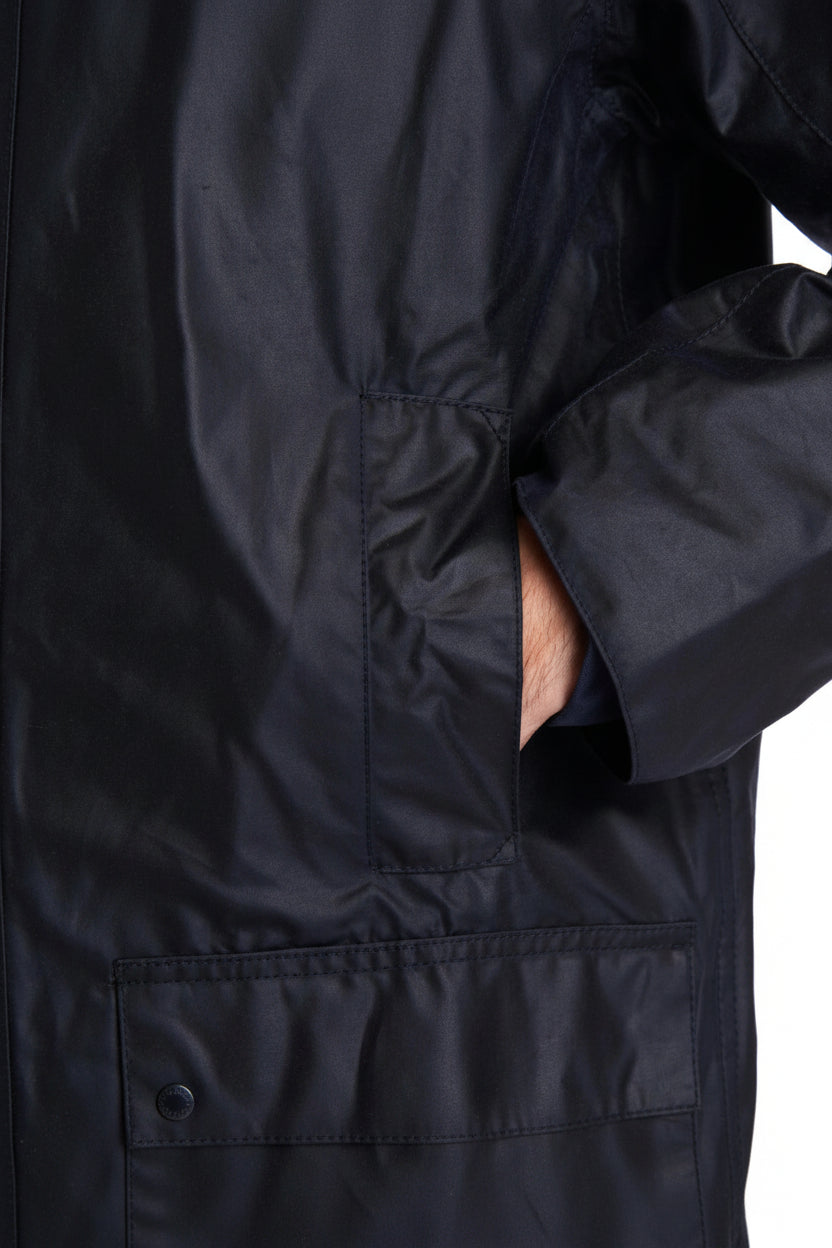 Men's navy wax jacket front with flap pockets and buttoned placket