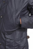 Navy wax jacket with flap chest pocket and buttoned front placket detail