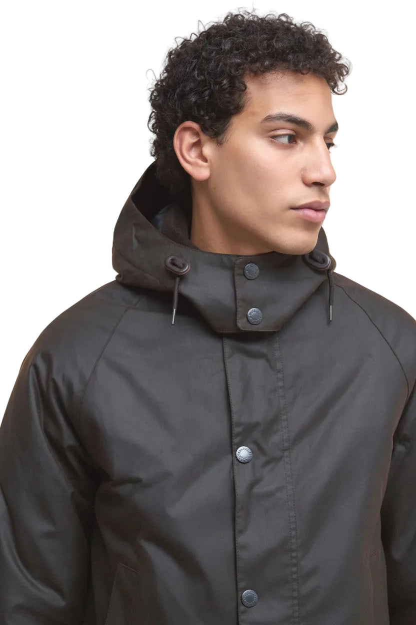 Dark waxed jacket with attached hood, snap placket, and metal button