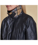 Navy wax jacket with plaid-lined stand collar and snap front detail
