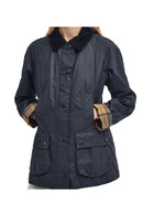 Navy women's wax jacket with plaid cuffs, front buttons, and multiple patch pockets