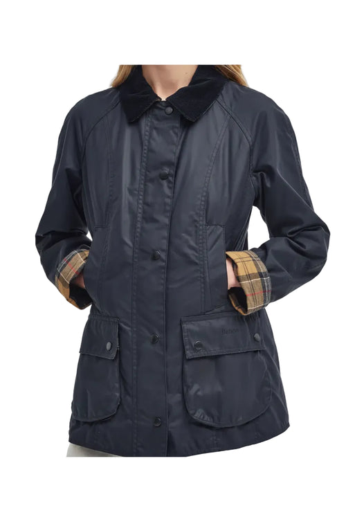 Navy women's wax jacket with plaid cuffs, front buttons, and multiple patch pockets